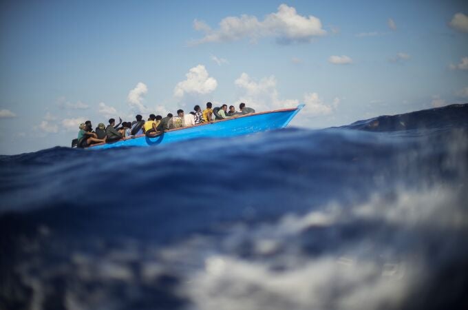 FILE - Migrants sail a wooden boat at south of the Italian Lampedusa island at the Mediterranean sea, Aug. 11, 2022. The back-to-back shipwrecks of migrant boats off Greece that left at least 22 people dead this week has once again put the spotlight on the dangers of the Mediterranean migration route to Europe. (AP Photo/Francisco Seco, file)
