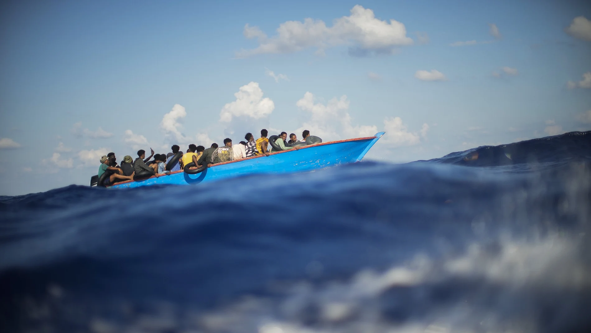 FILE - Migrants sail a wooden boat at south of the Italian Lampedusa island at the Mediterranean sea, Aug. 11, 2022. The back-to-back shipwrecks of migrant boats off Greece that left at least 22 people dead this week has once again put the spotlight on the dangers of the Mediterranean migration route to Europe. (AP Photo/Francisco Seco, file)