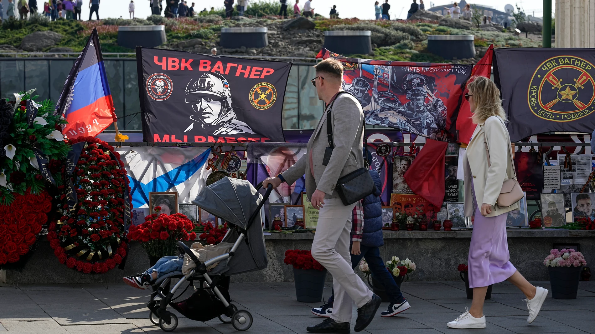 People look at an improvised memorial of Russian mercenary chief Yevgeny Prigozhin and others who died in a plane crash with him, on the eve of 40 days since their deaths, near the Kremlin, partially seen in the background, in Moscow, Russia, Saturday, Sept. 30, 2023. Prigozhin, the head of the Wagner military contractor, and nine other people, including his top associates, died when his private jet plummeted into a field northwest of Moscow shortly after taking off on Aug. 23. The authoritie...