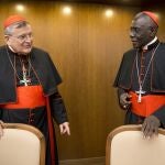 Cardinal Raymond Leo Burke, left, talks with Cardinal Robert Sarah, prefect of the Congregation for Divine Worship and the Discipline of the Sacraments. Five conservative cardinals are challenging Pope Francis to affirm Catholic teaching on homosexuality and female ordination. They've asked him to respond ahead of a big Vatican meeting where such hot-button issues are up for debate.