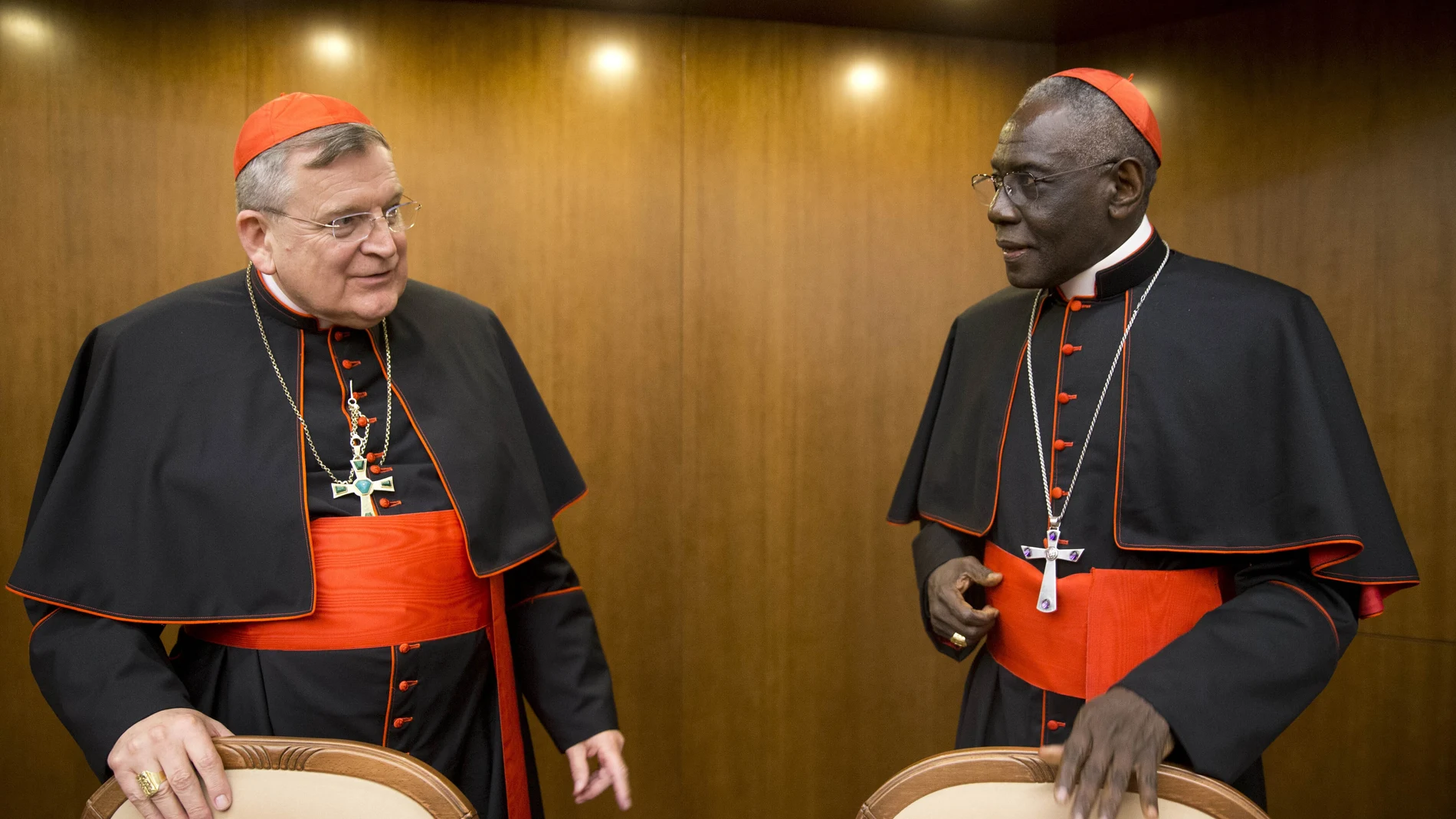 Cardinal Raymond Leo Burke, left, talks with Cardinal Robert Sarah, prefect of the Congregation for Divine Worship and the Discipline of the Sacraments. Five conservative cardinals are challenging Pope Francis to affirm Catholic teaching on homosexuality and female ordination. They've asked him to respond ahead of a big Vatican meeting where such hot-button issues are up for debate.