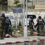 Israeli police station stands by the bodies of militants outside the police station that was overrun by Hamas gunmen on Saturday, in Sderot, Israel, Sunday, Oct.8, 2023. Hamas militants stormed over the border fence Saturday, killing hundreds of Israelis in surrounding communities. 