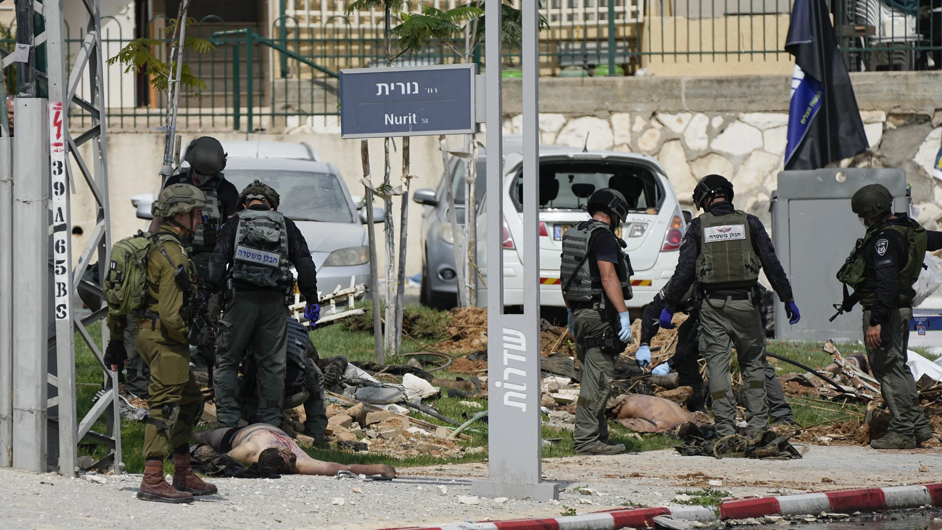 Israeli police station stands by the bodies of militants outside the police station that was overrun by Hamas gunmen on Saturday, in Sderot, Israel, Sunday, Oct.8, 2023. Hamas militants stormed over the border fence Saturday, killing hundreds of Israelis in surrounding communities.