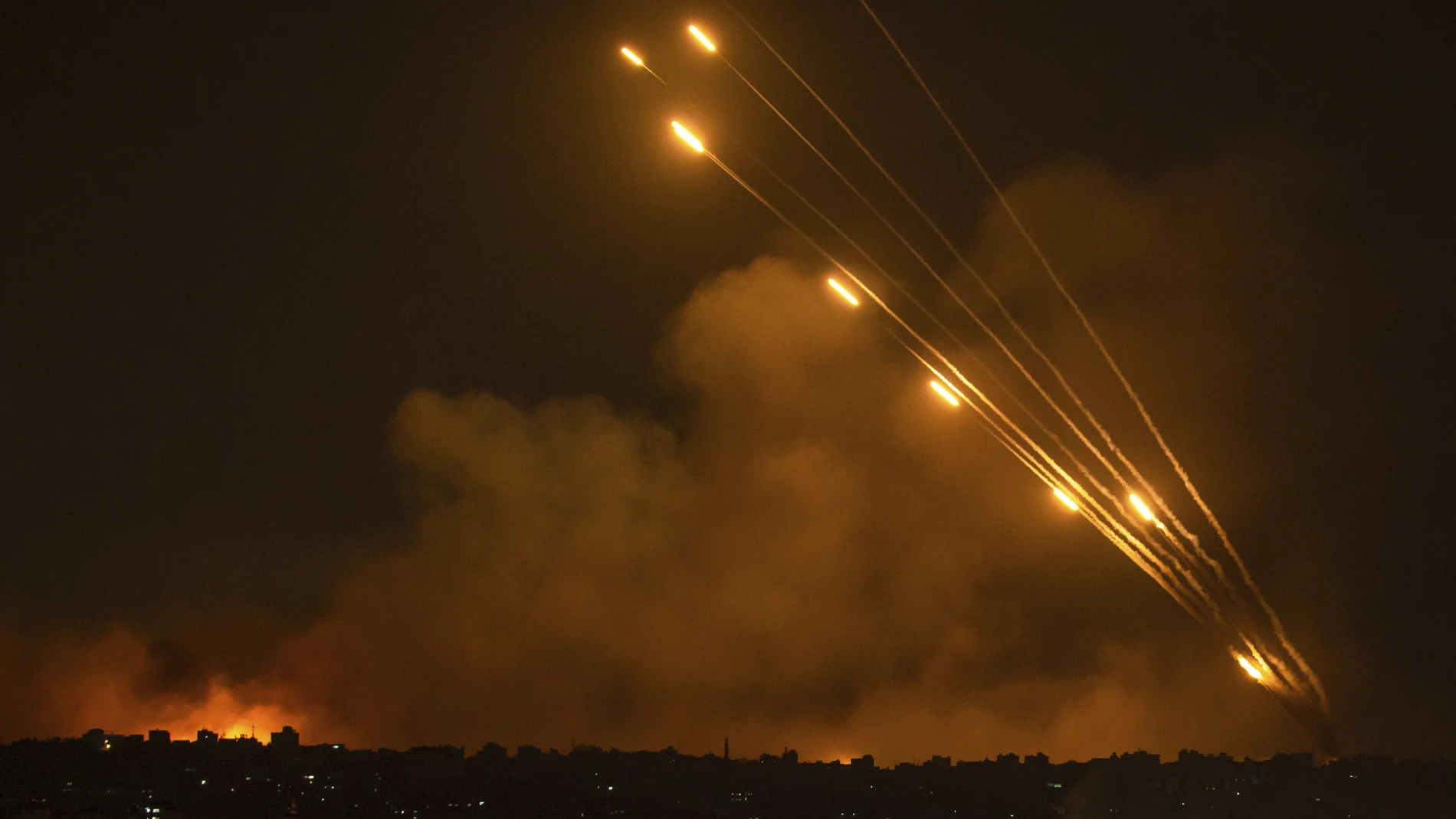 Rockets are fired toward Israel from the Gaza Strip, Sunday, Oct. 8, 2023.