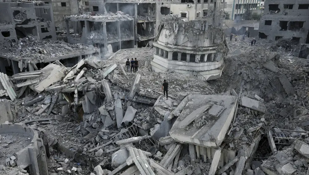Palestinians inspect the rubble of the Yassin Mosque destroyed after it was hit by an Israeli airstrike at Shati refugee camp in Gaza City, early Monday, Oct. 9, 2023. Israel's military battled to drive Hamas fighters out of southern towns and seal its borders Monday as it pounded the Gaza Strip. (AP Photo/Adel Hana.