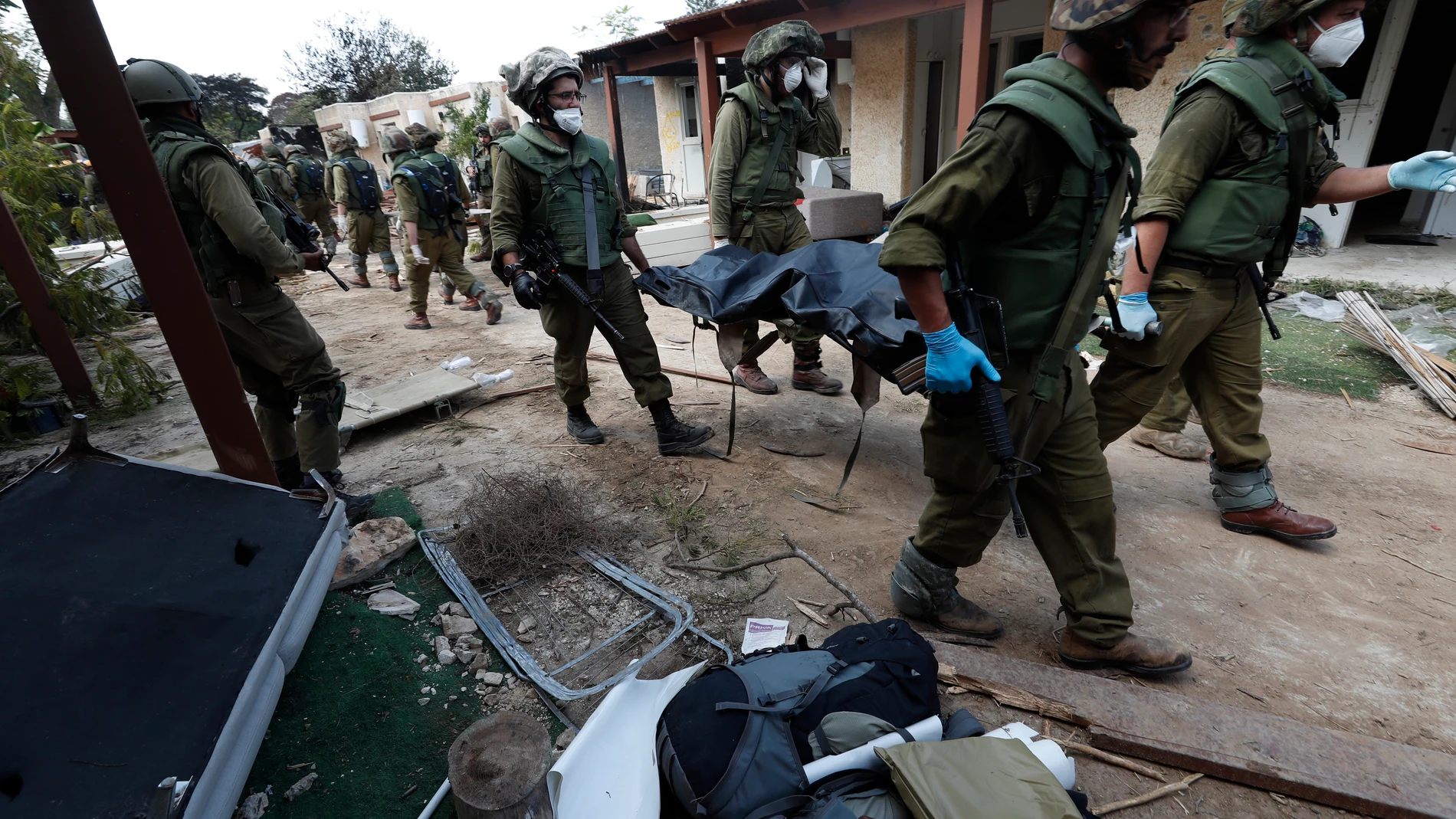 Kfar Aza (Israel), 10/10/2023.- Israeli soldiers take the bodies of Israelis killed in Kfar Aza kibbutz near the border with Gaza, 10 October 2023. More than 900 people have been killed, around 150 were taken as hostages, and 1,500 others injured, according to Israel Defence Forces (IDF), after the Islamist movement Hamas launched an attack against Israel on 07 October. More than 3,000 people, including 1,500 militants from Hamas, have been killed and thousands injured in Gaza and Israel sinc...