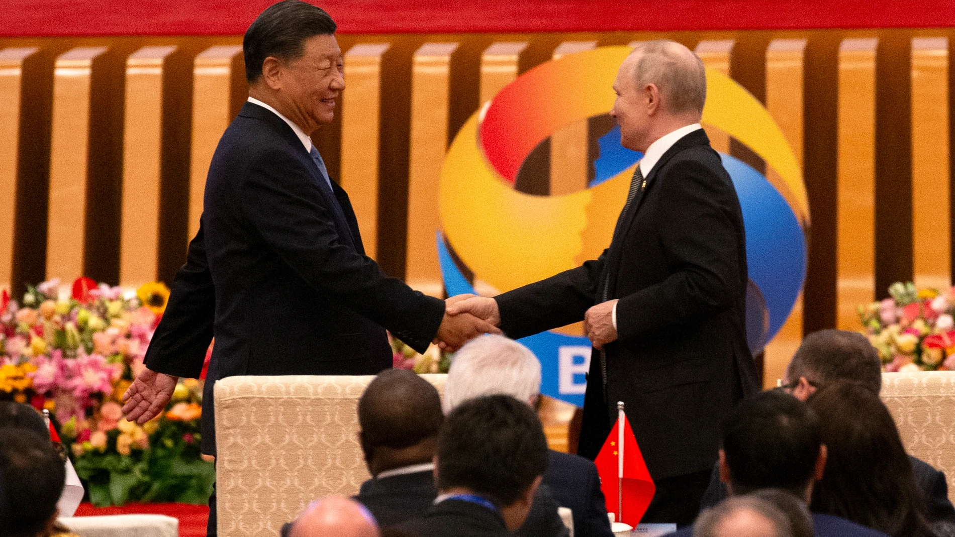 El presidente ruso, Vladímir Putin (d), y el presidente chino, Xi Jinping (i), se estrechan la mano