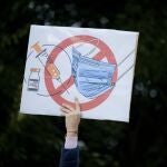 A woman holds a banner during an anti-government and anti-restrictions protest organised by the far-right Alliance for the Unity of Romanians or AUR, in Bucharest, Romania, Saturday, Oct. 2, 2021. Thousands took to the streets calling for the government's resignation, as Romania reported 12,590 new COVID-19 infections in the past 24 hour interval, the highest ever daily number since the start of the pandemic.