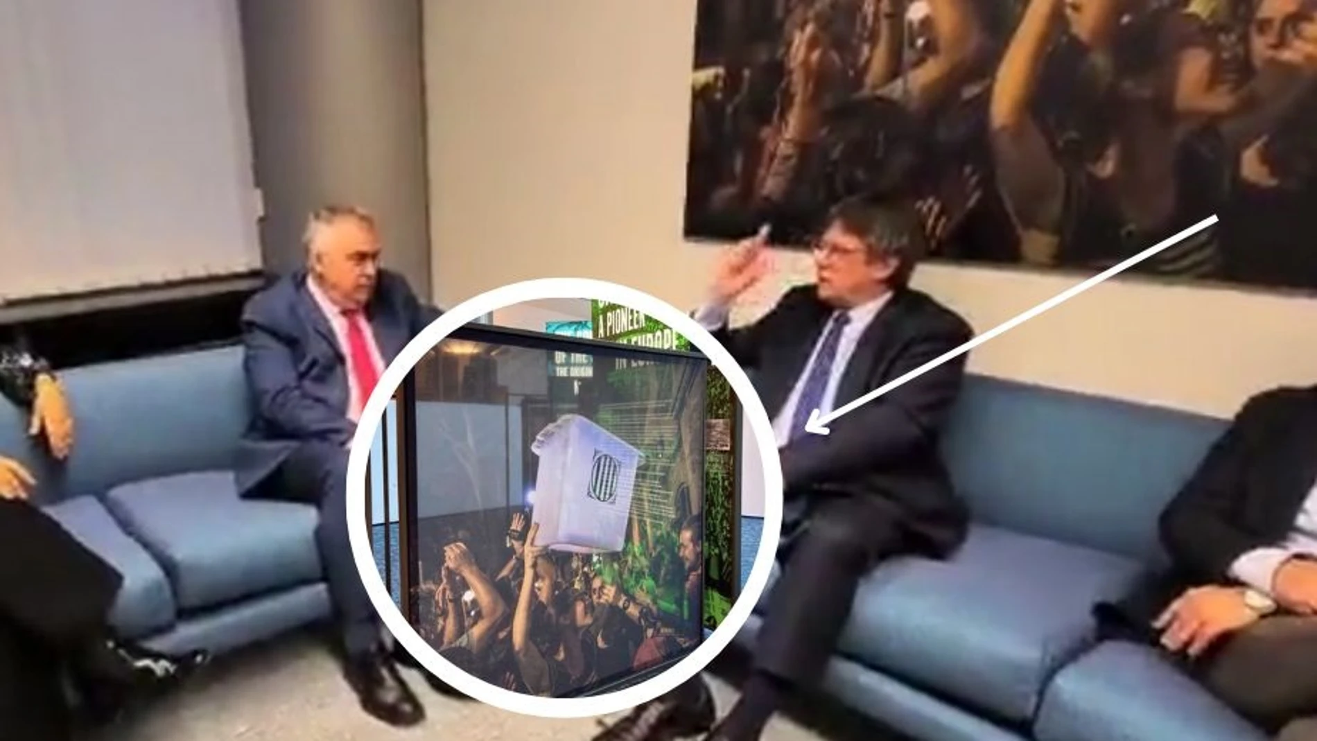AMP.- Cerdán y Puigdemont se reúnen en una sala con una foto de una urna del 1-O, retirada por el Parlamento Europeo