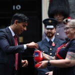 Britain'Äôs Prime Minister Rishi Sunak buys a poppy to support Armed Forces community