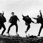 Photo of BEATLES; L-R: Ringo Starr, George Harrison, Paul McCartney, John Lennon - posed, group shot - jumping on wall, Used on the Twist & Shout EP cover 