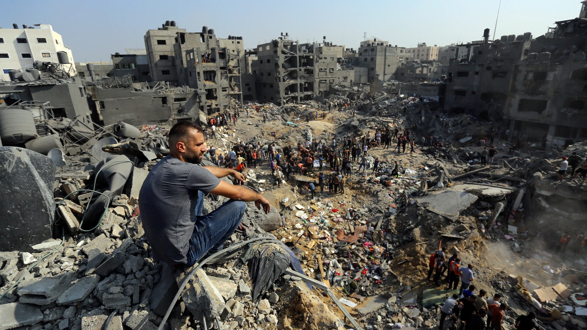 FILE - A man sits on the rubble as others wander among debris of buildings that were targeted by Israeli airstrikes in Jabaliya refugee camp, northern Gaza Strip on Nov. 1, 2023. Weeks after ordering northern Gaza's 1.1 million inhabitants to evacuate south, the Israeli army is intensifying its bombing of the area that stretches to the wetlands of Wadi Gaza. Israeli soldiers are also battling Hamas militants just north of Gaza City. It's the start of what officials expect to be a long and blo...