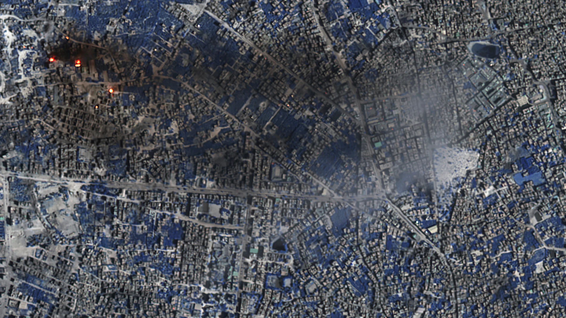 This image provided by Maxar Technologies shows a Shortwave Infrared (SWIR) close view of a number of burning buildings and active fires burning in Gaza City, Tuesday, Nov. 7, 2023. In SWIR satellite imagery, vegetation appears in shades of blue while active fires/thermal hot spots show up as an orange/yellow bloom. (Satellite image ©2023 Maxar Technologies via AP)