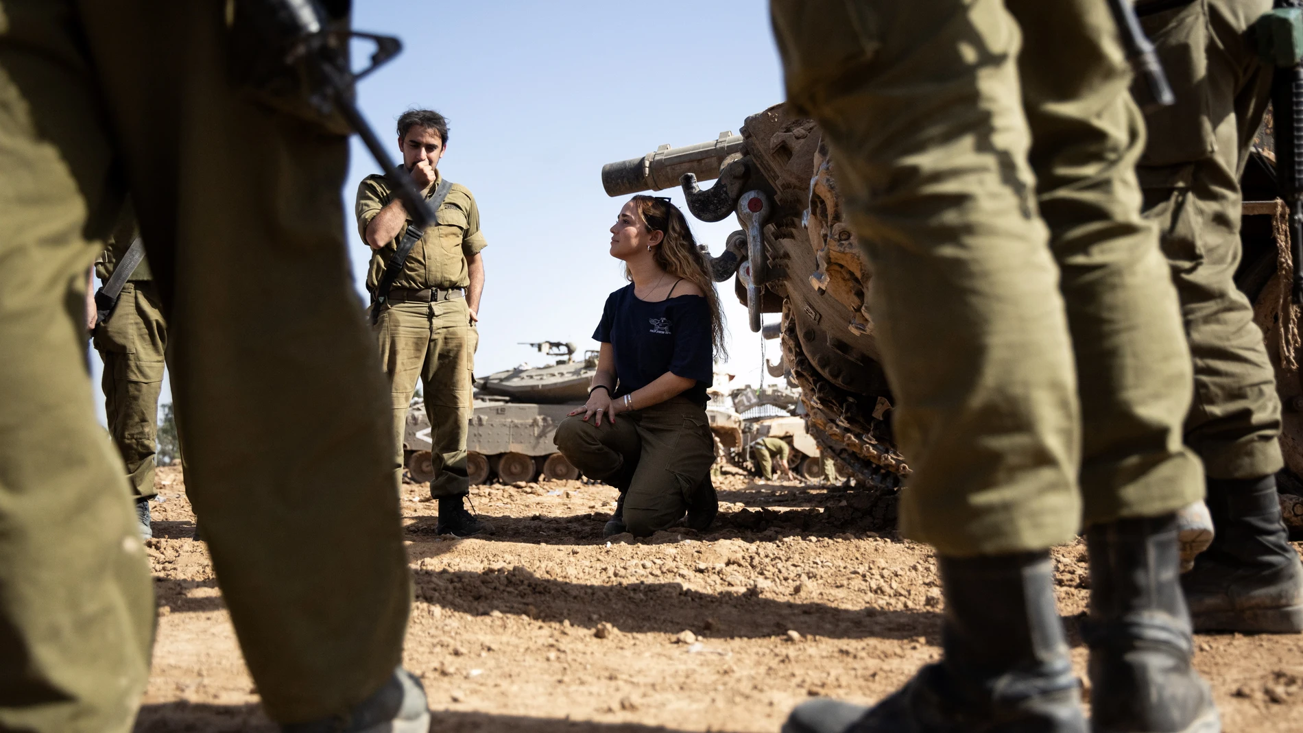 Undisclosed (Israel), 23/11/2023.- An Israeli army female soldier instructor (C) talks to soldiers next to a 'Merkava' battle tank at the border with the Gaza Strip, southern Israel, 23 November 2023. More than 12,700 Palestinians and at least 1,200 Israelis have been killed, according to the Israel Defense Forces (IDF) and the Palestinian health authority, since Hamas militants launched an attack against Israel from the Gaza Strip on 07 October, and the Israeli operations in Gaza and the Wes...