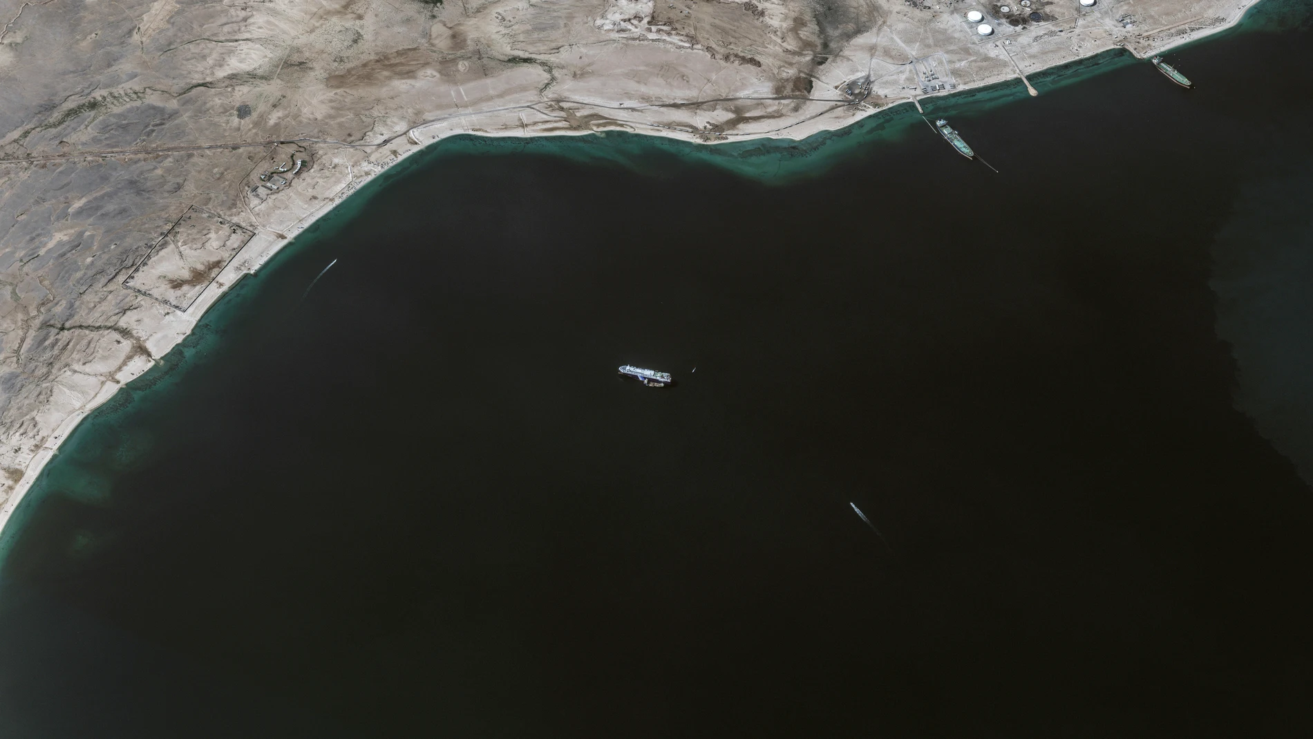 This satellite image provided by Maxar Technologies shows the Galaxy Leader ship anchored offshore of As Salif, Yemen, in the Red Sea, on Tuesday, Nov. 28, 2023. A support tender vessel is positioned nearby. The ship was captured by Houthi fighters on Nov. 19. (Satellite image ©2023 Maxar Technologies via AP)