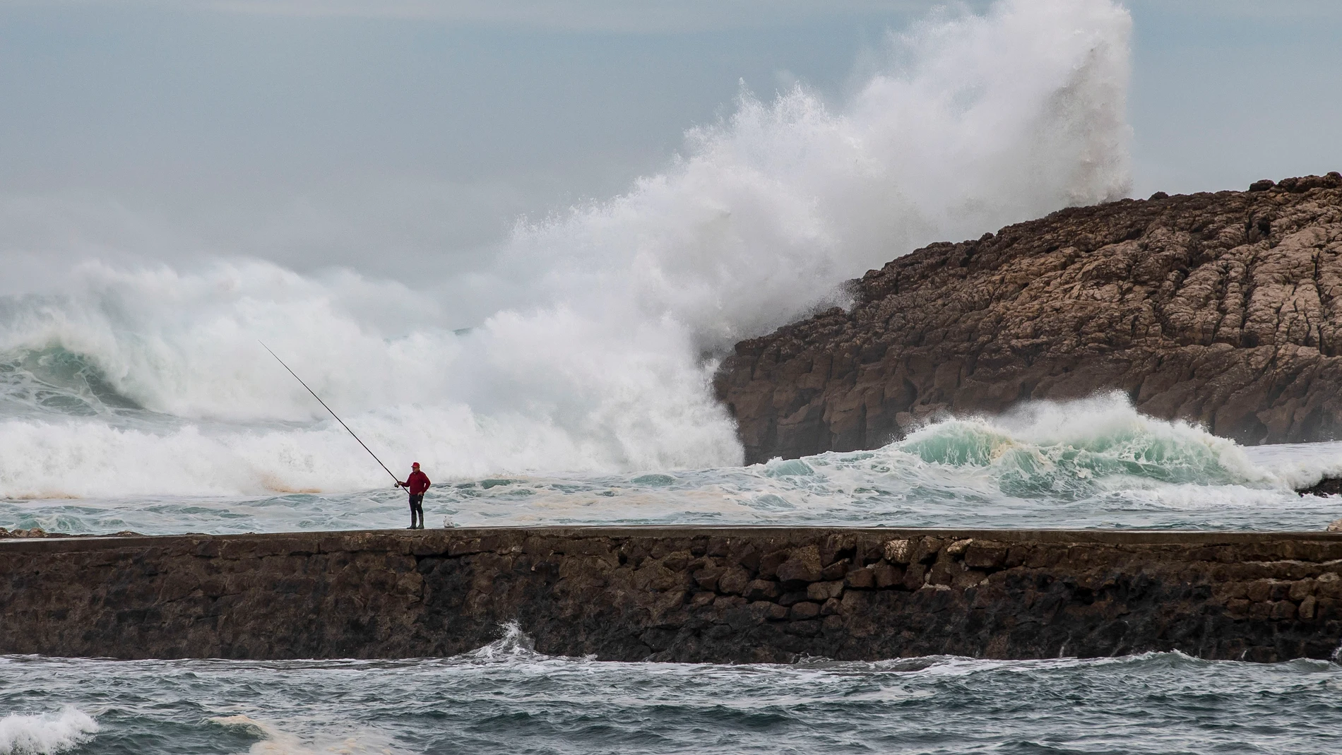 SUANCES (CANTABRIA), 11/12/2023.- Un hombre pesca este lunes en el rompeolas de la localidad cántabra de Suances. Este martes un frente avanzará por el noroeste peninsular y dejará otra vez lluvia en Galicia, que en el oeste de la Comunidad podrán ser fuertes, y, de forma más débil, en puntos de Castilla y León y el Cantábrico acompañadas de fuerte viento en Galicia, Comunidades Cantábricas y sistema Ibérico. EFE/Pedro Puente Hoyos 