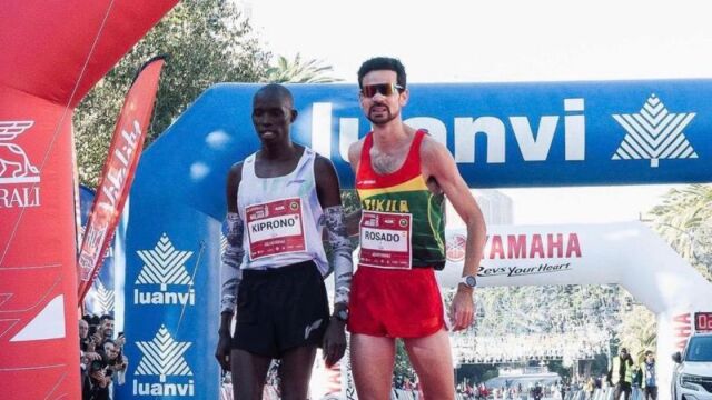 El español Ricardo Rosado ayuda en la línea de meta al keniata Kimtai Kiprono en la maratón de Málaga