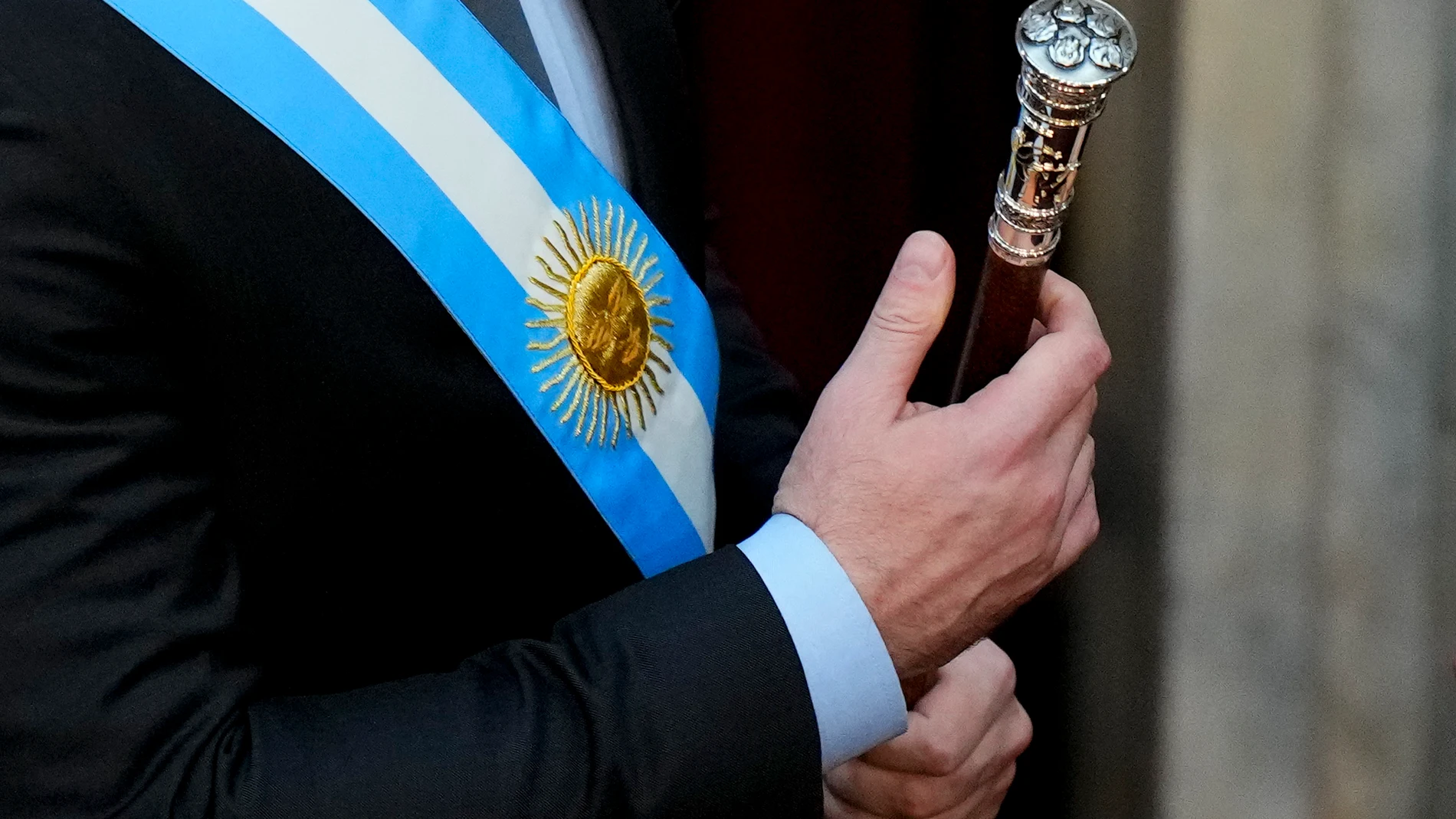 Argentina's incoming President Javier Milei holds the presidential cane at the Congress in Buenos Aires, Argentina, Sunday, Dec. 10, 2023. (AP Photo/Natacha Pisarenko)