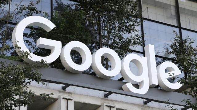 A Google sign hangs over an entrance to the company's new building, in New York.