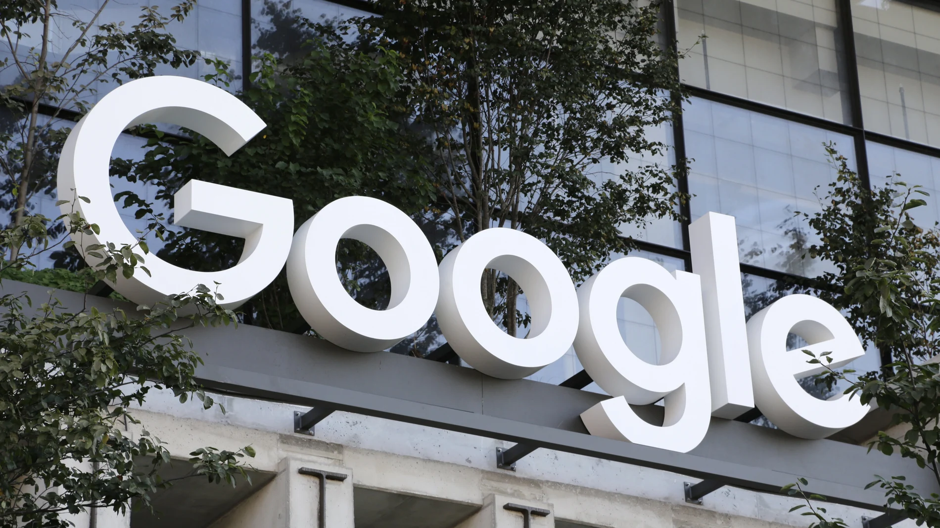 A Google sign hangs over an entrance to the company's new building, in New York.