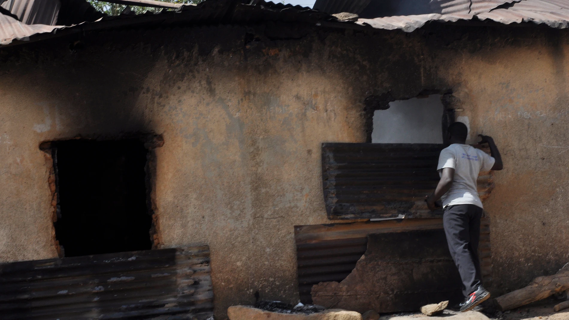 A man inspect a burnt out house following an attacked by gunmen in Bokkos, north central Nigeria, Tuesday, Dec. 26, 2023. Nigerian officials and survivors say at least 140 people were killed by gunmen who attacked remote villages in north-central Nigeria's Plateau state in the latest of such mass killings this year blamed on the West African nation's farmer-herder crisis. (AP Photo)