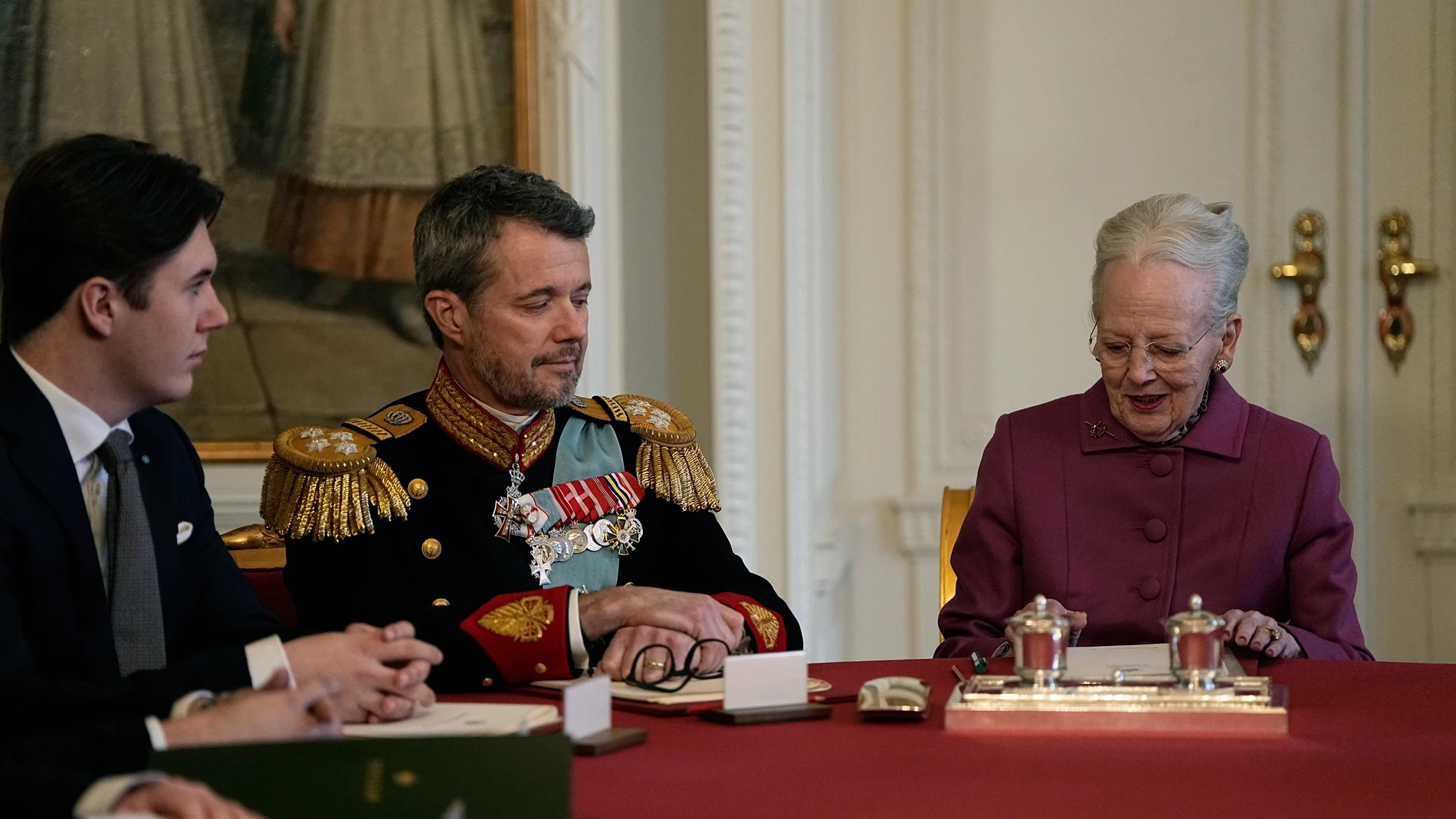 Denmark's Queen Margrethe II signs a declaration of abdication in the meeting of the Council of State at Christiansborg Castle in Copenhagen, Sunday, Jan. 14, 2024. Queen Margrethe II has signed her historic abdication, a step that paves the way for her son Frederik X to immediately become king. (Mads Claus Rasmussen/Ritzau Scanpix via AP)