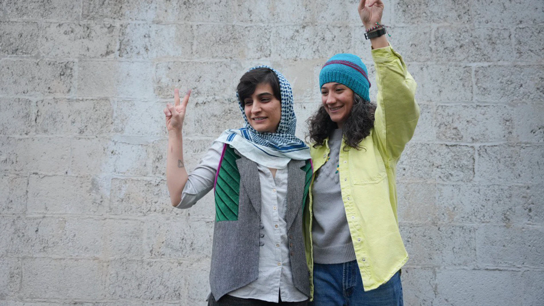 Iranian journalists Niloufar Hamedi, right, and Elaheh Mohammadi, flash the victory sign after being released from prison, in Tehran, Iran, Sunday, Jan. 14, 2024. The two who were serving long prison sentences over their coverage of the death of Mahsa Amini have been released on bail pending their appeal, Iranian media reported Sunday. (Sahand Taki, Shargh Daily News, via AP)