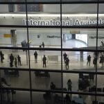People in the arrivals area at Heathrow Airport in London.