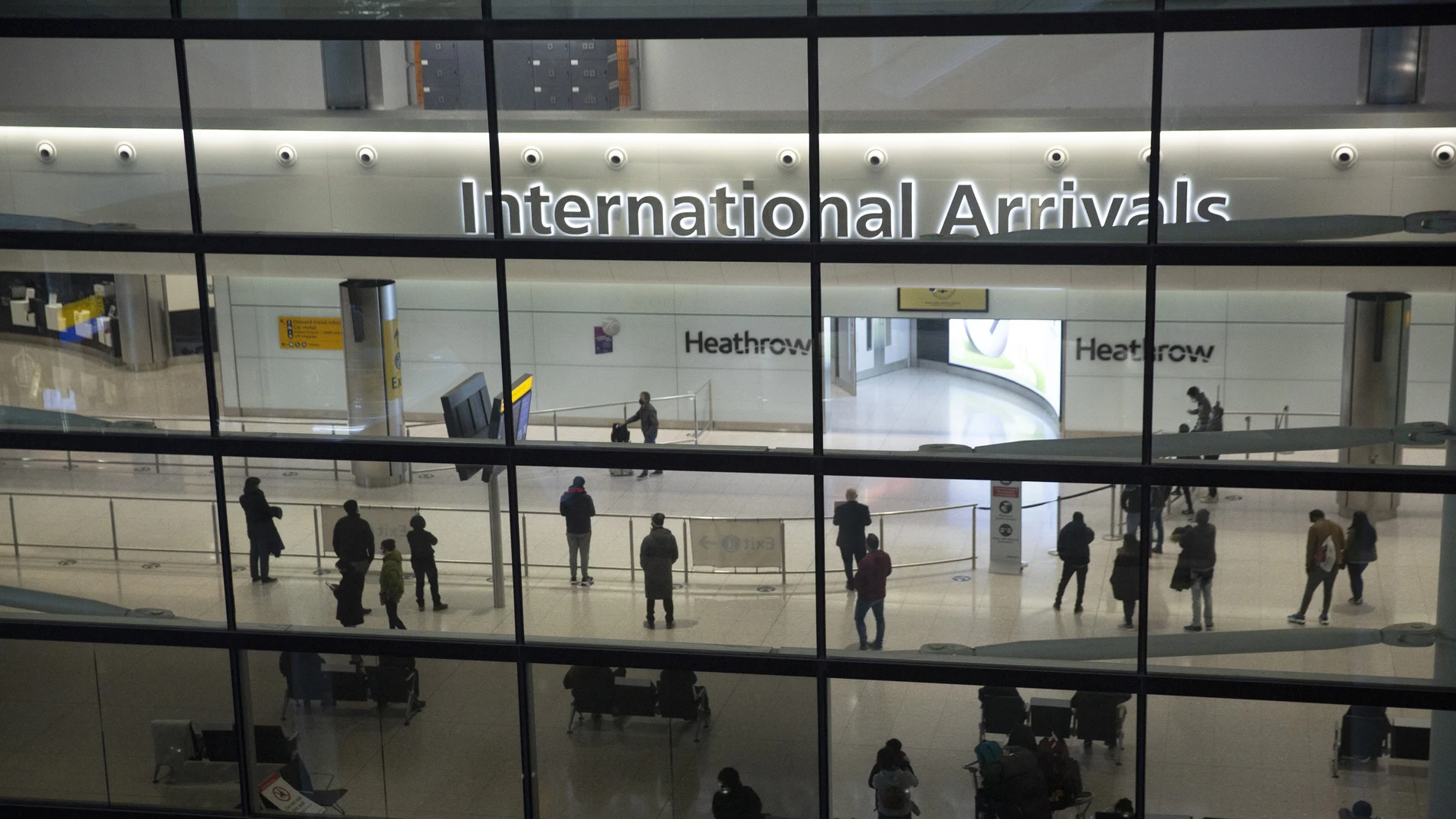 People in the arrivals area at Heathrow Airport in London.