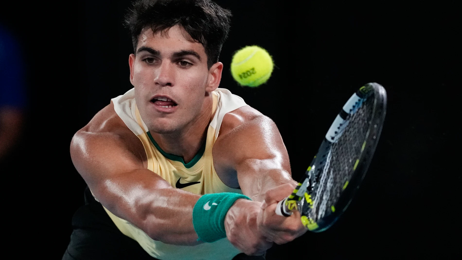 Carlos Alcaraz of Spain plays a backhand return to Richard Gasquet of France during their first round match at the Australian Open tennis championships at Melbourne Park, Melbourne, Australia, Tuesday, Jan. 16, 2024. (AP Photo/Andy Wong)