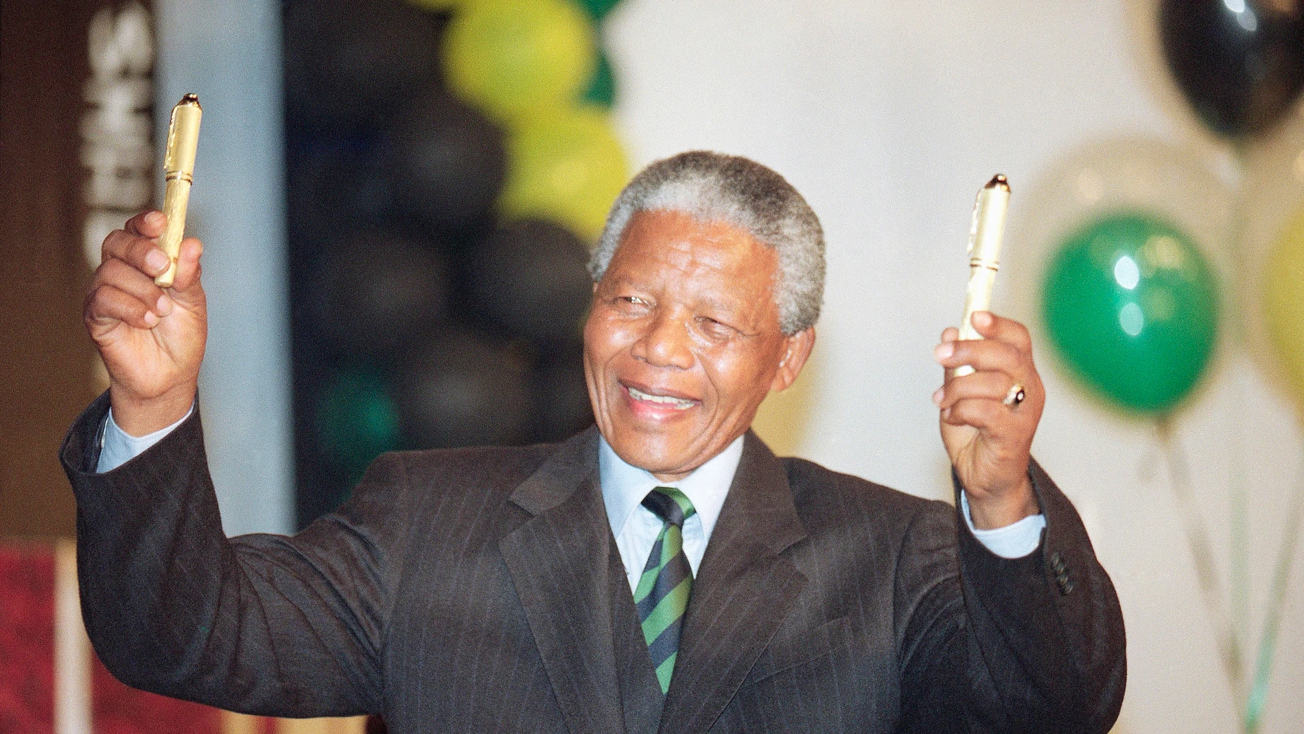 FILE - Nelson Mandela wears a pin-striped suit during victory celebration in Johannesburg, on May 2, 1994. The South African government announced Friday Jan. 19, 2024 that it plans to challenge an auction of artifacts which belonged to Mandela, set to take place in New York next month. (AP Photo/John Parkin, File)