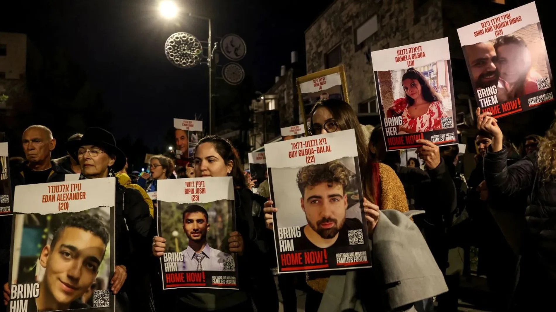 Manifestantes en Jerusalén sostienen retratos de rehenes israelíes retenidos en Gaza en una manifestación el 22 de enero de 2024 para exigir su liberación