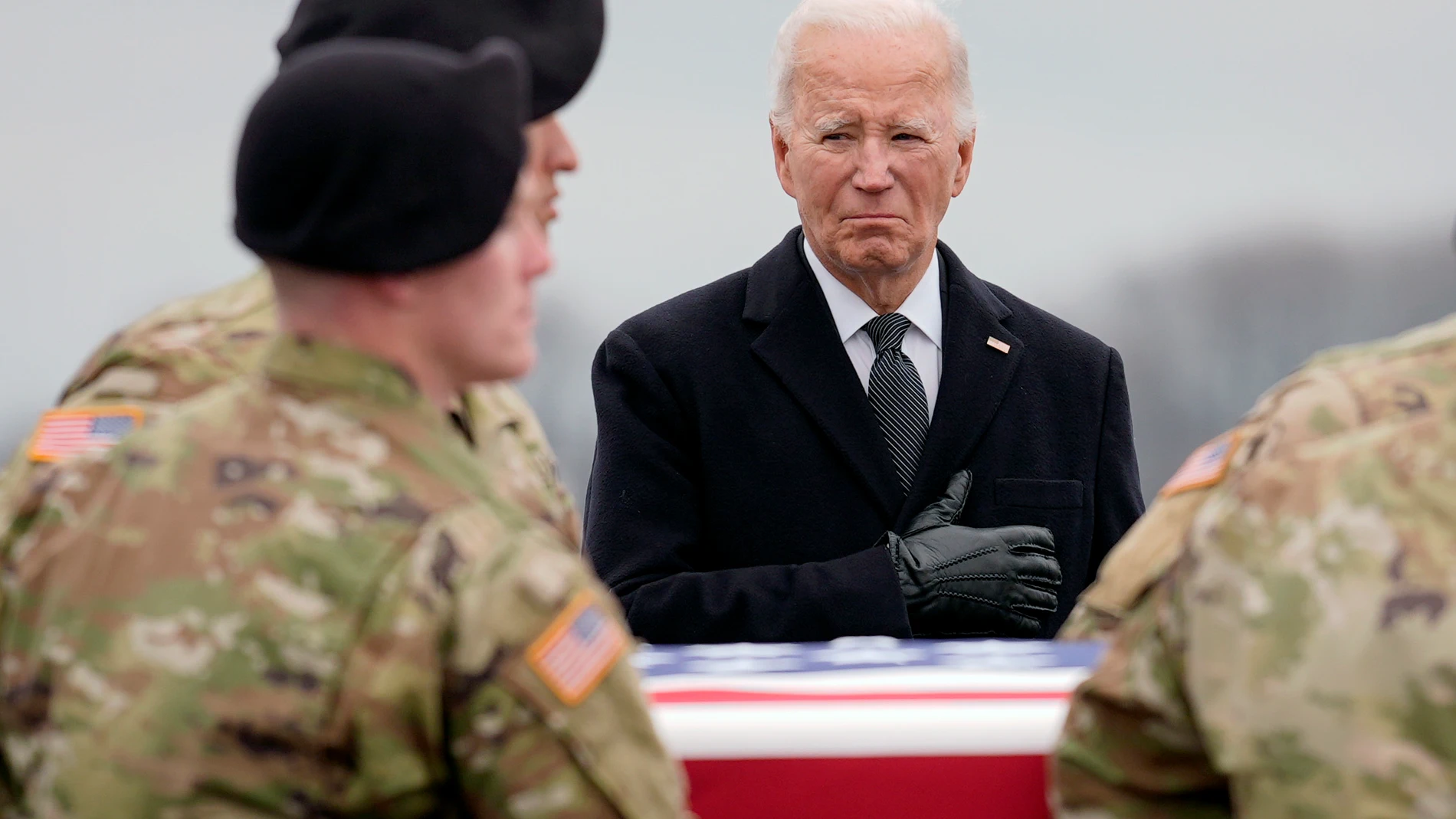President Joe Biden stands as an Army carry team moves the transfer case containing the remains of U.S. Army Sgt. Kennedy Ladon Sanders, 24, of Waycross, Ga., at Dover Air Force Base, Del., Friday, Feb. 2, 2024. Sanders was killed in a drone attack in Jordan on Jan. 28. (AP Photo/Matt Rourke)