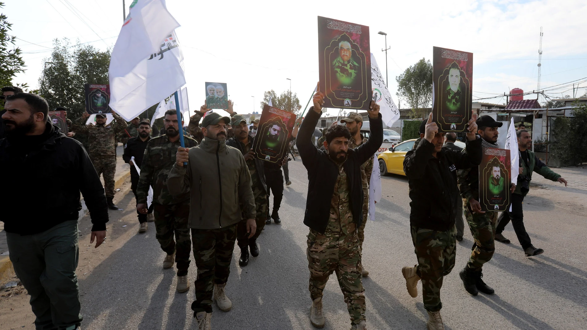 Baghdad (Iraq), 02/04/2024.- Members of the Iraqi Shiite Popular Mobilization Forces (PMF) carry images of their comrades, who were killed in recent US air strikes in western Iraq, during a funeral procession in Baghdad, Iraq, 04 February 2024. The United States Central Command (CENTCOM) said on 02 February it carried out airstrikes in Iraq and Syria on more than 85 targets against Iran's Islamic Revolutionary Guards Corps (IRGC) Quds Force and affiliated militia groups. The US attacks were i...