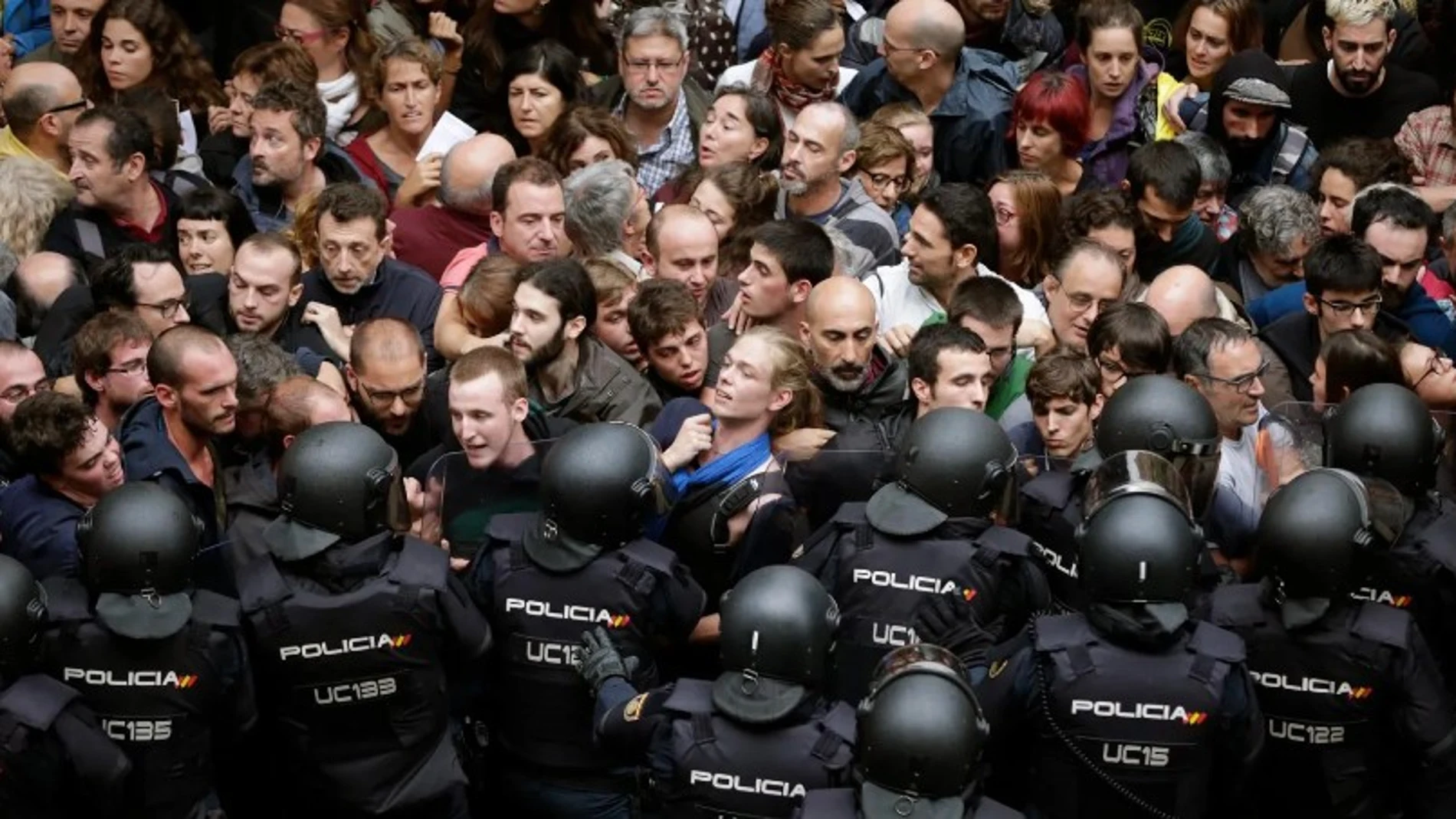 Agentes antidisturbios de la Policía Nacional forman un cordón de seguridad en los alrededores del colegio Ramón Llull de Barcelona el 1-O