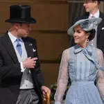 William, Prince of Wales, speaks with his wife Kate, Princess of Wales, during a Garden Party at Buckingham Palace, in celebration of the coronation.
