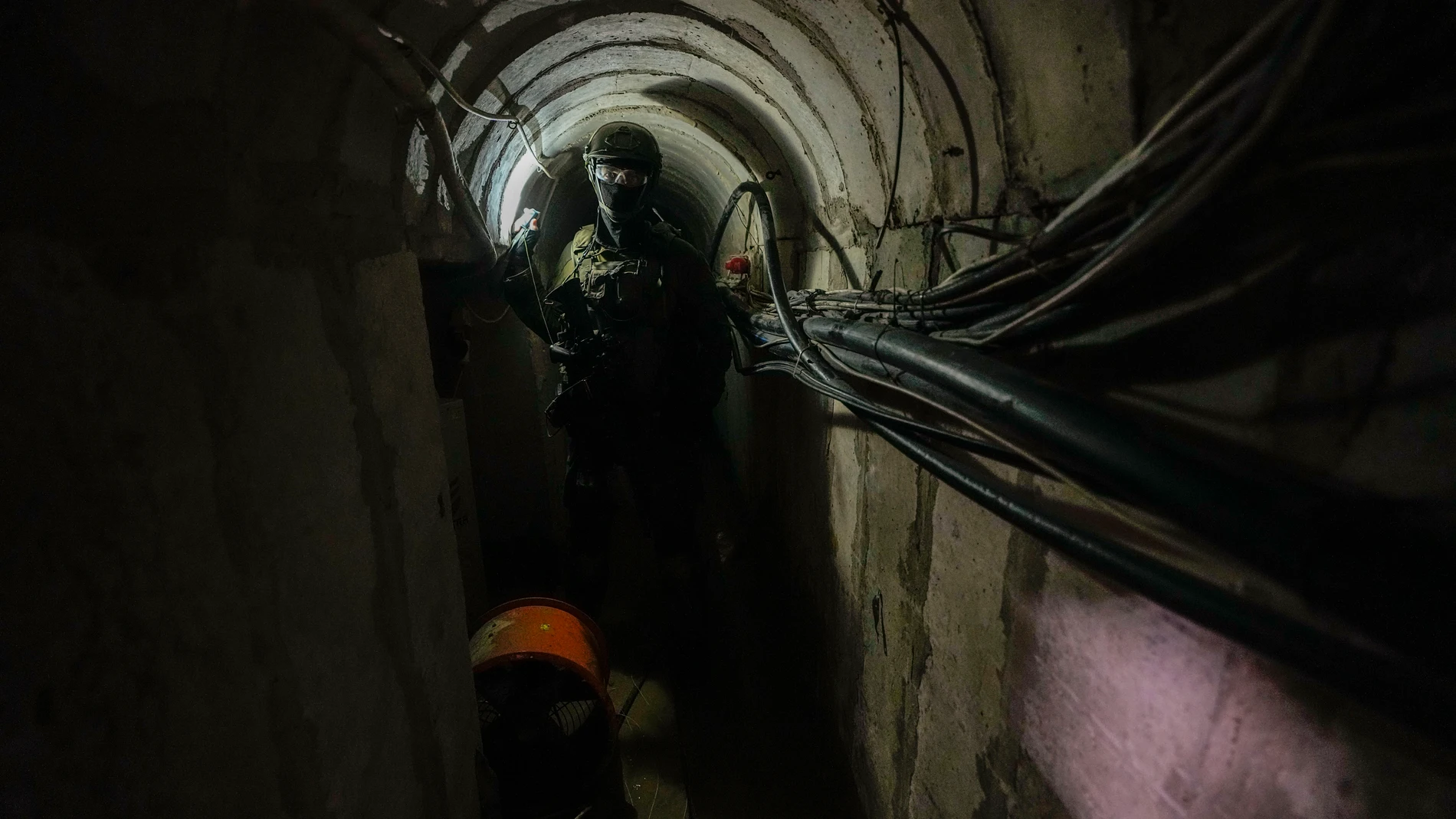 An Israeli soldier holds a light inside a tunnel underneath UNRWA compound, where the military discovered tunnels in the main headquarters of the U.N. agency that the military says Hamas militants used to attack its forces during a ground operation in Gaza, Thursday, Feb. 8, 2024. The Israeli military says it has discovered tunnels underneath the main headquarters of the U.N. agency for Palestinian refugees in Gaza City, alleging that Hamas militants used the space as an electrical supply roo...
