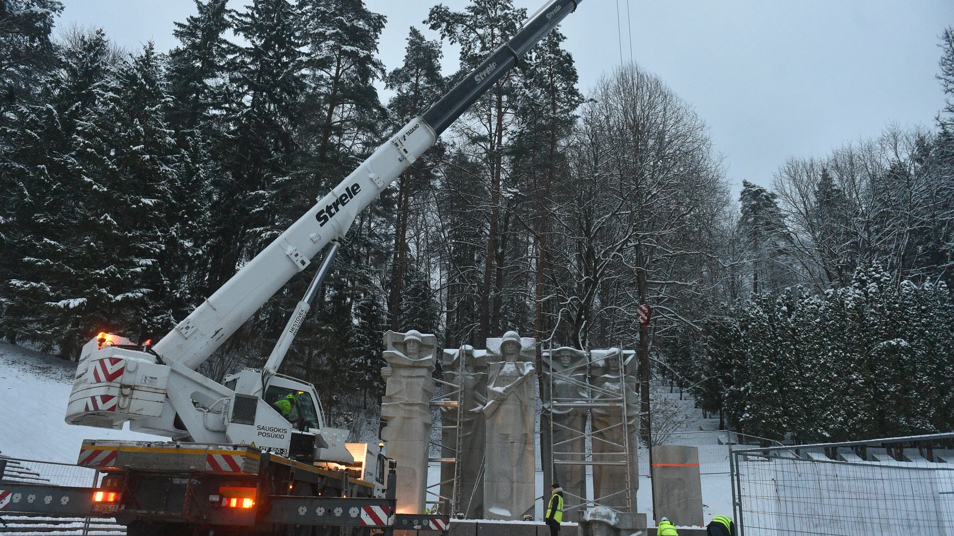 FILE - Municipal workers dismantle the memorial of the Red Army Soldiers who died during the liberation of Vilnius from Nazi invaders during WWII at the Antakalnis Memorial Cemetery in Vilnius, Lithuania, Wednesday, Dec. 7, 2022. Estonia and other NATO members - Latvia and Lithuania - have sought to remove the monuments widely seen as a legacy of Soviet occupation of the countries. Moscow has denounced those moves as a desecration of memory of Soviet soldiers who fell while fighting the Nazis...