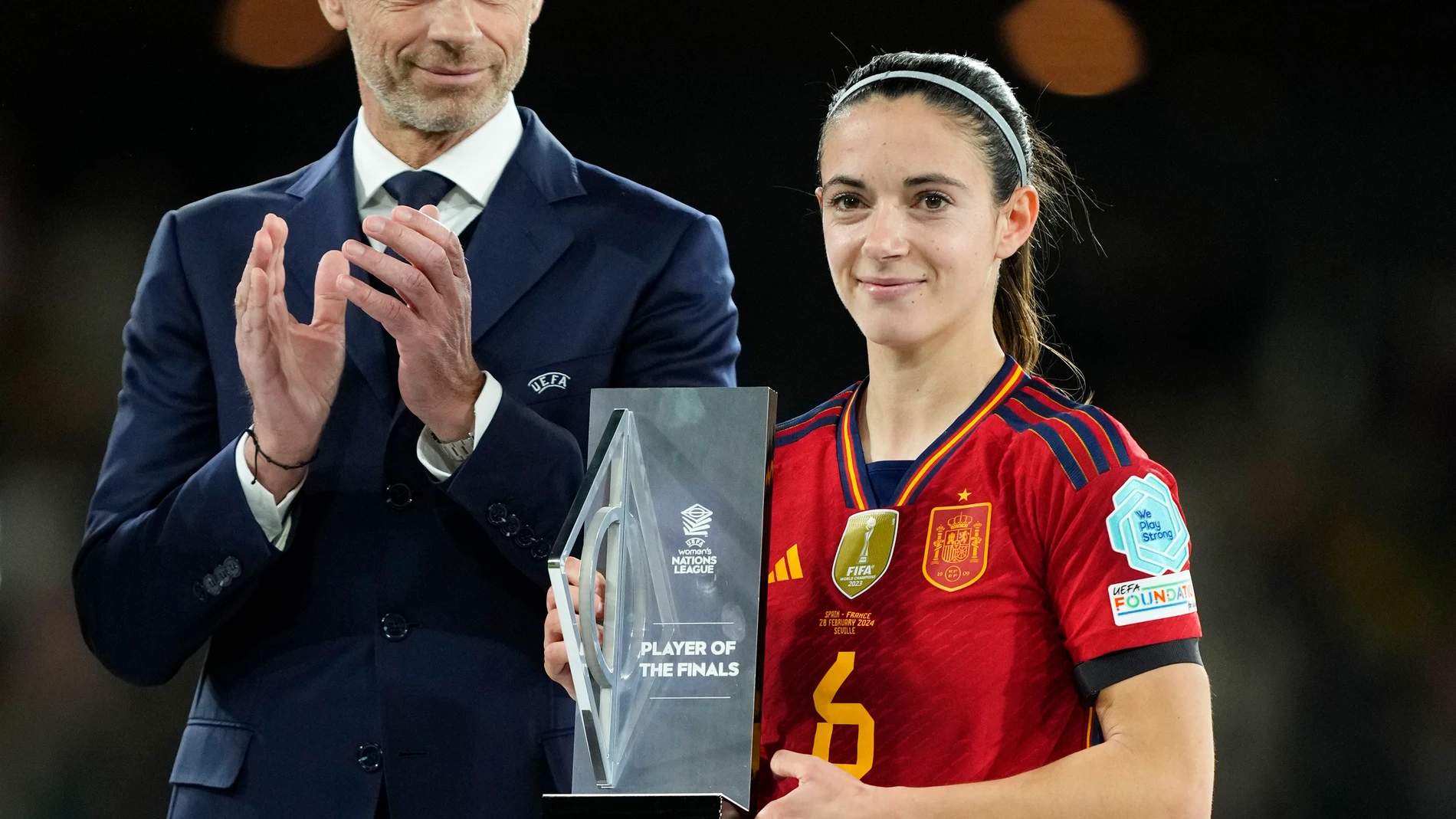 UEFA President Aleksander Ceferin applauds as Spain's Aitana Bonmati poses with her Best Player award after winning the Women's Nations League final soccer match between Spain and France at La Cartuja stadium in Seville, Spain, Wednesday, Feb. 28, 2024. Spain won 2-0. (AP Photo/Jose Breton)