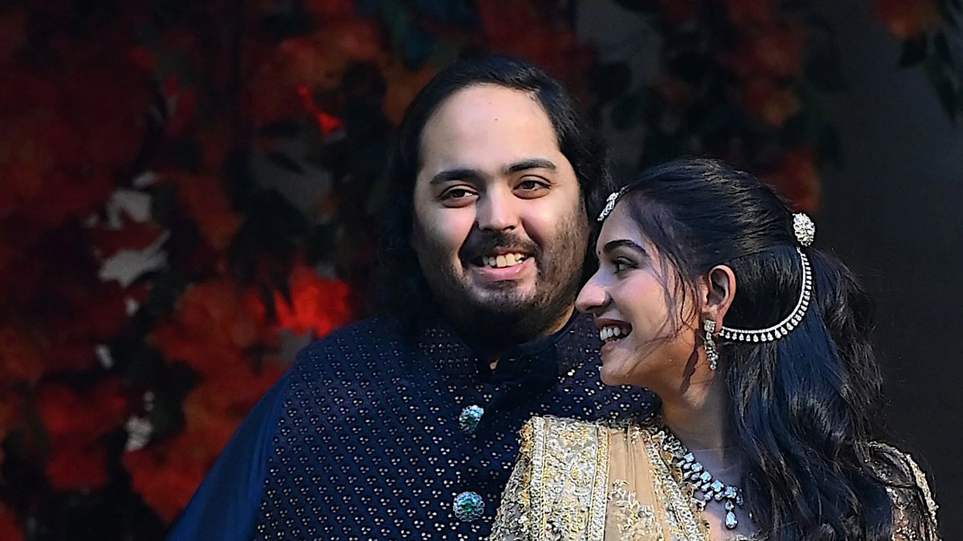 Anant Ambani (L), the son of Indian billionaire Mukesh Ambani, poses with his fiancée Radhika Merchant during their engagement ceremony in Mumbai
