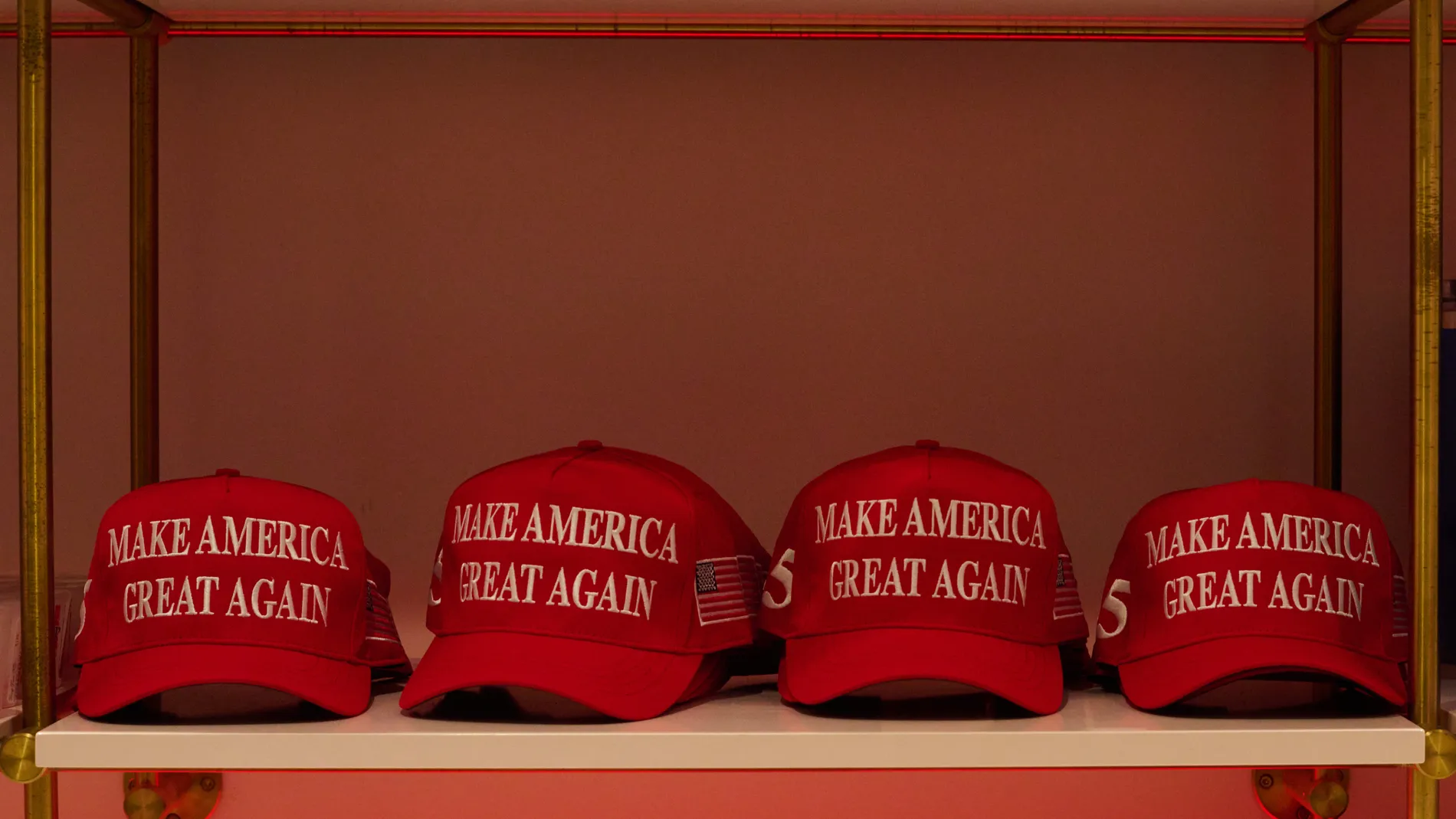 February 26, 2024, New York, New York, USA: Red caps printed with "Make America Great Again" sit on a shelf in the souvenir shop of Trump Tower at 725 5th Avenue. 26/02/2024
