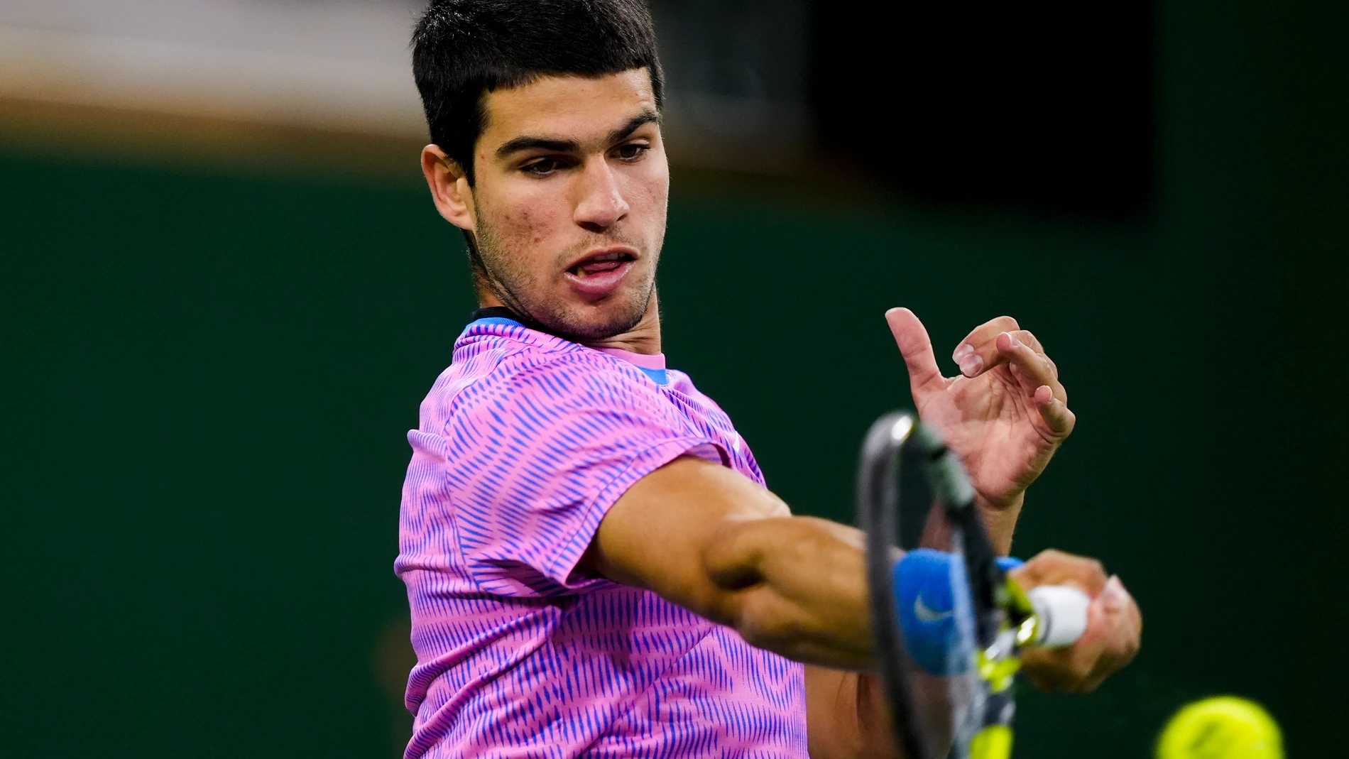 Carlos Alcaraz, of Spain, returns a shot against Matteo Arnaldi, of Italy, at the BNP Paribas Open tennis tournament in Indian Wells, Calif., Friday, March 8, 2024. (AP Photo/Ryan Sun)