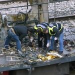 Forensic experts inspect the trains which exploded at the Atocha train station the day before, 12 March 2004 in Madrid. At least 198 people were killed and more than 1400 wounded in bomb attacks on four commuter trains, 11 March 2004.