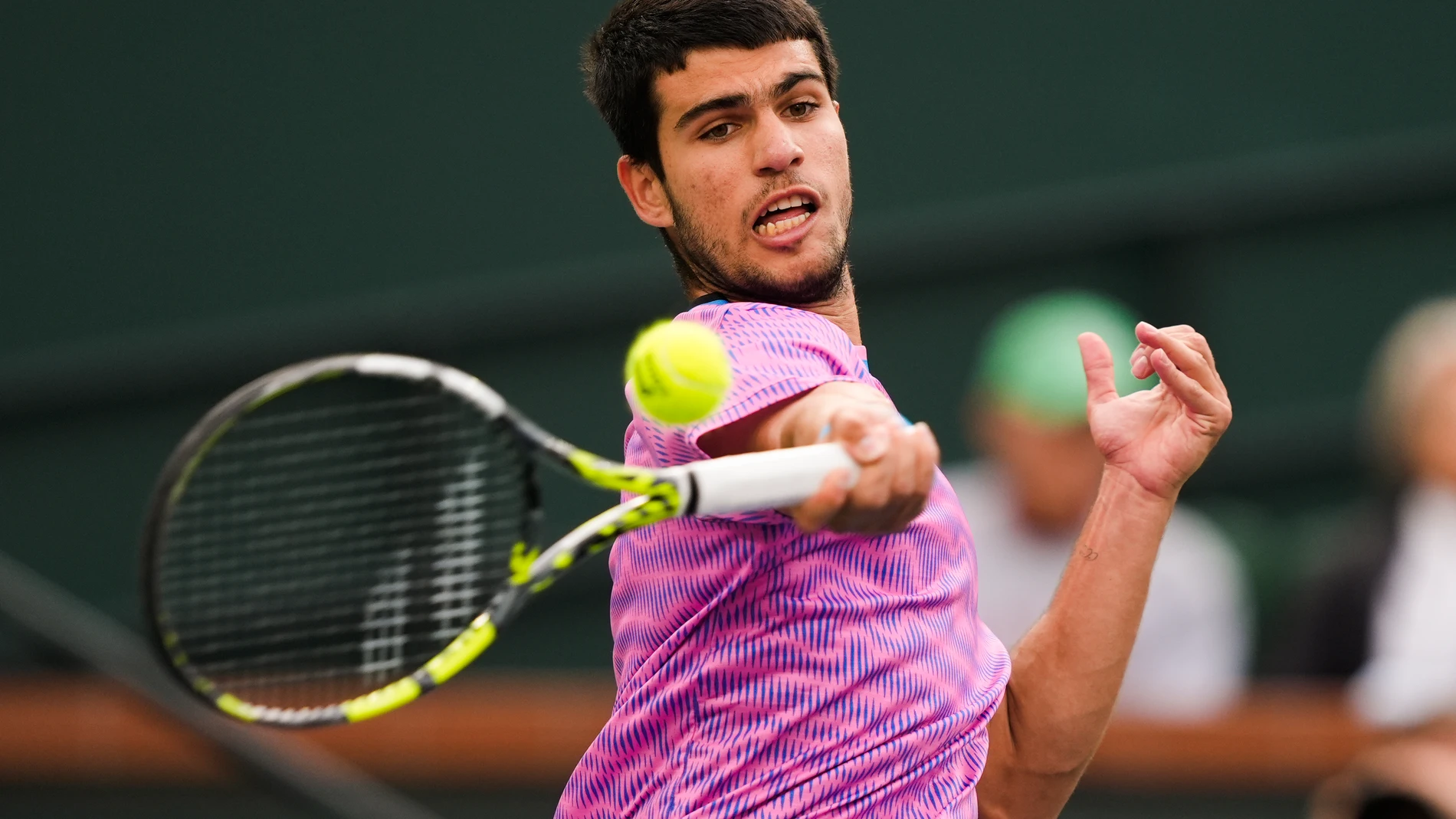 Carlos Alcaraz, of Spain, hits a forehand to Jannik Sinner, of Italy, during a semifinal at the BNP Paribas Open tennis tournament in Indian Wells, Calif., Saturday, March 16, 2024. (AP Photo/Ryan Sun)