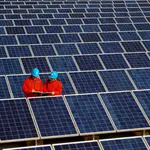 Workers check solar panels at a solar power station on a factory roof in Changxing, eastern China&#39;s Zhejiang province. 