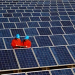 Workers check solar panels at a solar power station on a factory roof in Changxing, eastern China's Zhejiang province. 