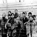 The file picture taken just after the liberation by the Soviet army in January, 1945, shows a group of children wearing concentration camp uniforms including Martha Weiss who was ten years-old, 6th from right, at the time behind barbed wire fencing in the Oswiecim (Auschwitz) Nazi concentration camp. 