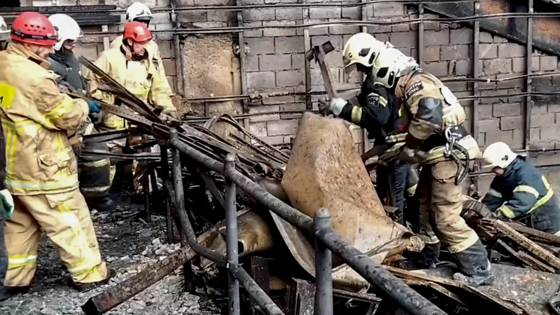 Krasnogorsk (Russian Federation), 23/03/2024.- A still image taken from a handout video made available by the Russian Ministry of Emergency Situations shows rescuers clearing the rubble and extinguishing fires in the hall of the Crocus City Hall concert venue following a shooting attack in Krasnogorsk, outside Moscow, Russia, 23 March 2024. On the evening of 22 March, a group of gunmen attacked the Crocus City Hall in the Moscow region, Russian emergency services said. According to the Russia...
