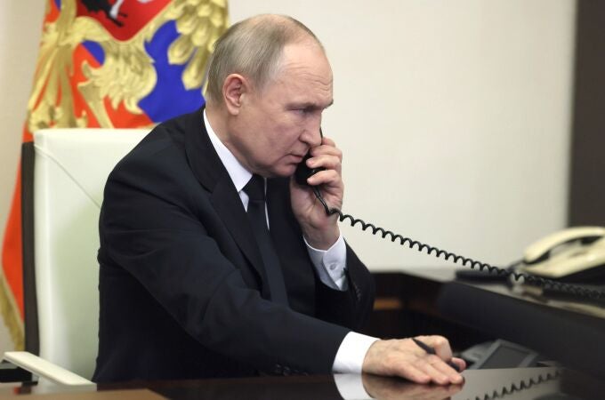 Russian President Vladimir Putin speaks over the phone during his address, the day after a terror attack on the Crocus City Hall in Krasnogorsk.