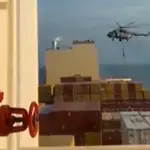 This image grab taken from a UGC video posted on social media on April 13, 2024 shows Iran&#39;s Revolutionary Guards rappelling down onto a container ship named, MSC Aries, near the Strait of Hormuz. - Iran&#39;s Revolutionary Guards on Saturday seized a container ship &quot;related to the Zionist regime (Israel) in the Gulf,&quot; 